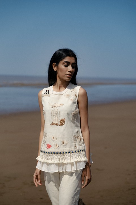 Off-white handwoven hand embroidered short top with tassel detailing