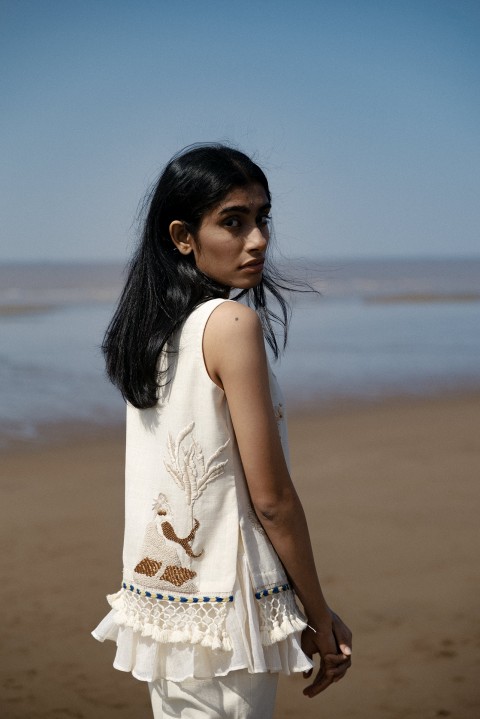 Off-white handwoven hand embroidered short top with tassel detailing